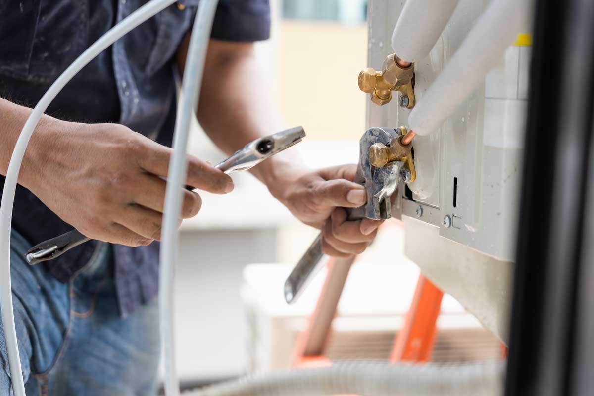 HVAC technician performing heat pump services in Plantersville, TX, providing installation and maintenance for efficient year-round home comfort